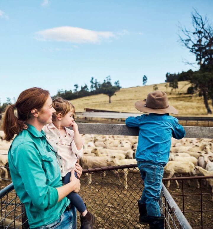 Image of mother with two children at sheep yards