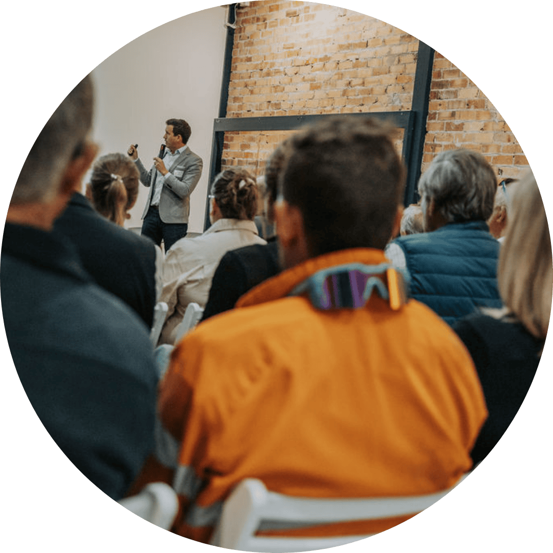man delivering financial advice to diverse audience